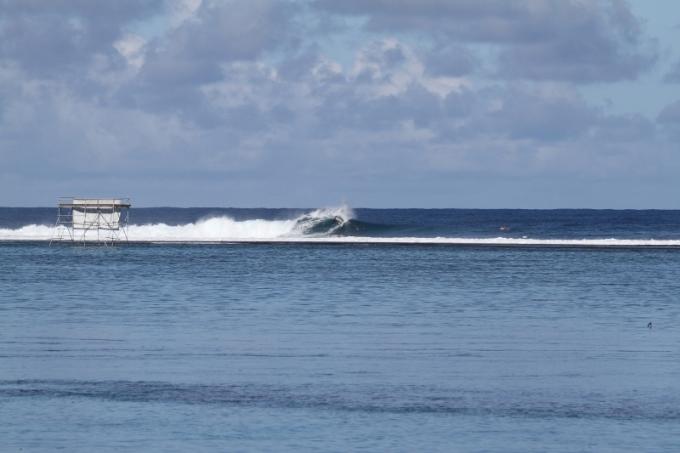 Adrian Buchan surfs small Teahupoo