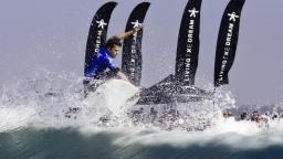 Dane Reynolds with flags in background