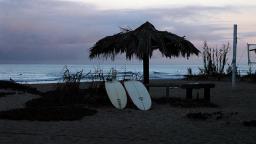 Shade umbrella and two surfboards