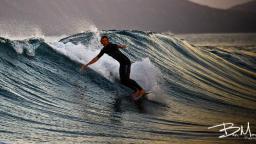 surfing harbour wall with Island Boarders surf school