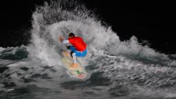 Russell Winter surfing at night