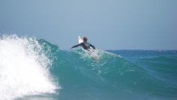 Surfer on top of the wave paddling out