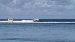 Adrian Buchan surfs small Teahupoo