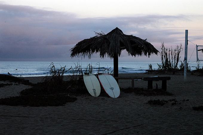 Shade umbrella and two surfboards