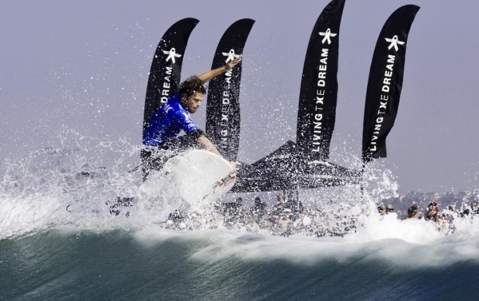 Dane Reynolds with flags in background