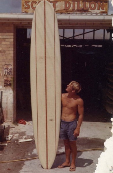 55 Man standing with board outside Scott Dillon shaping bay.jpg