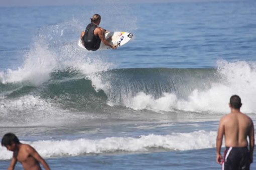 Angelo Lozano Pulling a nice air in small waves