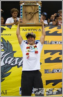 Joel Parkinson holding Vans Triple Crown Trophy Aloft